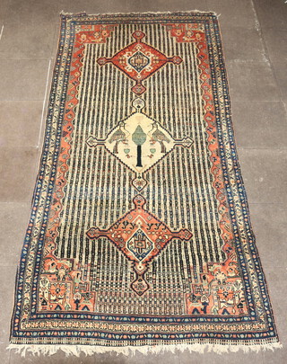 A white, blue and orange ground Western Persian rug, the centre with 3 medallions, the central medallion decorated a tree and 2 birds within a 3 row border 312cm x 155cm 
