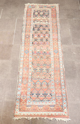 A brown, black and green ground Caucasian runner with all over geometric design within a 4 row border 352cm x 95cm 