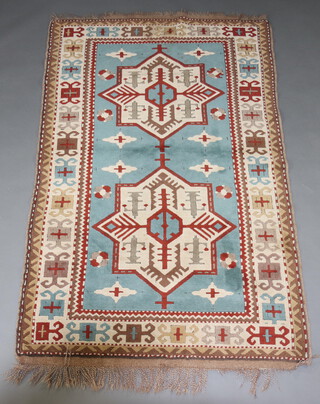 A blue, white and brown ground Afghan rug with 2 stylised medallions within a multi row border 201cm x 130cm 