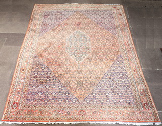 A pink, blue and white ground Persian carpet with central diamond shaped medallion 393cm x 296cm 