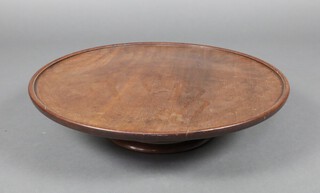 An Edwardian Georgian style circular turned mahogany lazy Susan, raised on a spreading foot 12cm x 50cm