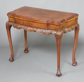 A 1930's Queen Anne style figured walnut card table of serpentine outline, raised on cabriole supports 80cm h x 99cm w x 49cm 