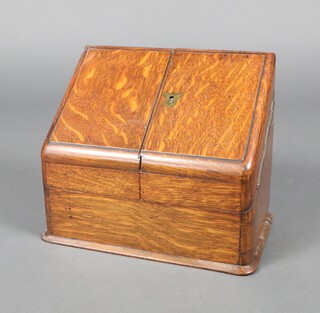 A Victorian oak wedge shaped stationery box with hinged lid and stepped interior 24cm x 29cm x 18cm 