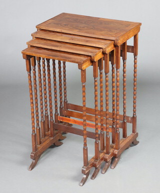 A nest of 4 Edwardian rectangular quarter veneered and crossbanded walnut coffee tables, raised on bobbin turned supports 79cm h x 52cm w x 30cm d 
