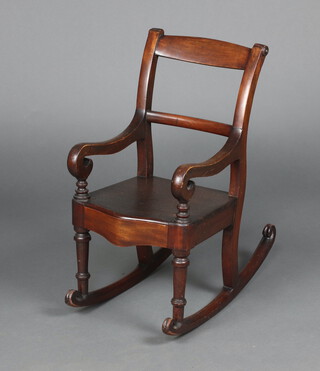 A child's 19th Century mahogany bar back rocking chair with solid seat of serpentine outline 64cm h x 56cm w x 31cm d  