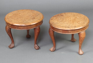 A  pair of 1920's circular bleached walnut stools/occasional tables, raised on cabriole ball and claw supports 31cm h x 38cm diam. 