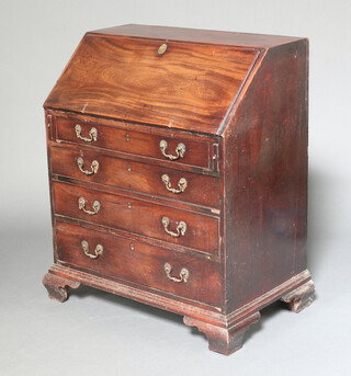 A Georgian mahogany bureau, the fall front revealing a well fitted interior with pigeon holes and drawers, above 4 long drawers, raised on ogee bracket feet 100cm h x 82cm w x 50cm d 