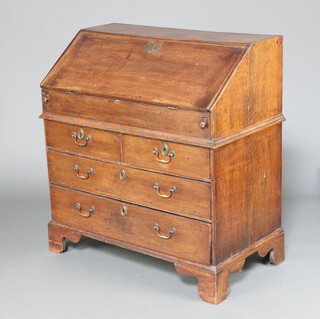 A 17th/18th Century oak bureau with stepped interior fitted a well, the base fitted 2 short and 2 long drawers (possible replacement handles) raised on bracket feet 102cm h x 91cm w x 52cm d  