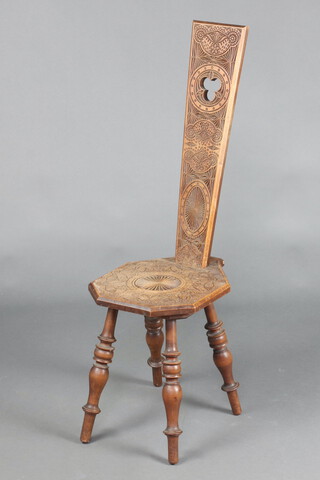 A carved mahogany spinning chair with shaped seat, raised on turned supports, the back dated 1920 99cm h x 31cm w x 40cm d 