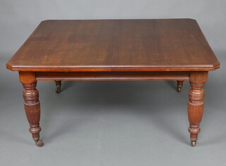 A Victorian mahogany extending dining table with 3 extra leaves, raised on turned and reeded supports 74cm h x 139cm w x 152cm l x 299cm l when fully extended, complete with winder  