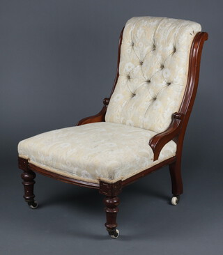 A Victorian mahogany show frame nursing chair upholstered in white material raised on turned supports 84cm h x 60cm w x 60cm 