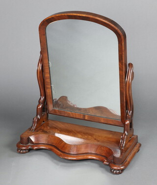 A Victorian arched plate dressing table mirror contained in a mahogany frame, the base of serpentine outline 80cm h x 68cm w x 31cm d 