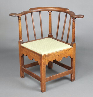 An 18th Century oak corner chair with turned rails and upholstered seat, raised on square tapered supports, 76cm h x 80cm w x 60cm d  