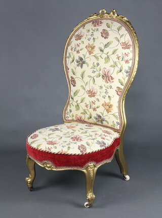 A Victorian gilt painted show frame nursing chair upholstered in tapestry material raised on cabriole supports 108cm h x 53cm w x 53cm d 