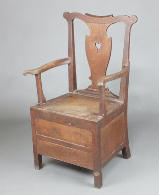 A Georgian elm commode chair with pierced vase shaped slat back, raised on square supports 101cm h x 64cm w x 43cm d 