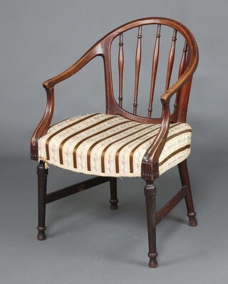 An Edwardian mahogany tub back open armchair upholstered in Regency stripe, raised on turned supports 89cm h x 57cm w x 50cm d 