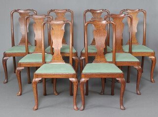 A set of 8 Queen Anne style oak slat back dining chairs with upholstered drop in seats on cabriole supports 