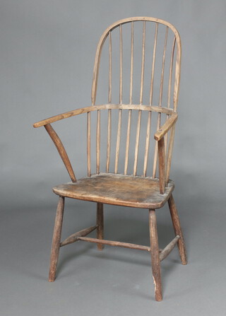 An 18th/19th Century bleached elm stick and rail back carver chair with solid seat, raised on turned supports, 119cm h x 63cm w x 37cm d 