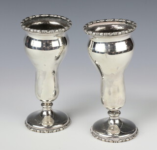 A pair of Edwardian silver waisted vases with egg and dart decoration, Sheffield 1903, 500 grams, 19cm 