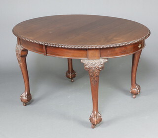 A 1930's Chippendale style oval extending dining table with gadrooned border, raised on cabriole supports 74cm h x 104cm w x 134cm l 