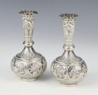 A pair of Indian white metal repousse tapered vases decorated with deities 13cm 