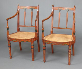 A pair of Edwardian Sheraton style painted satinwood open arm chairs with woven cane seats, each 85cm h x 54cm w x 46cm d