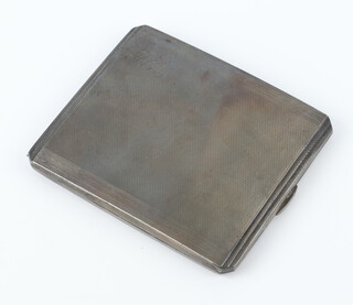 A silver engine turned cigarette case 131 grams gross, Birmingham 1938, engraved monogram 