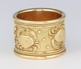Elizabeth Gage, a yellow metal 18ct wide wedding band decorated with the star sign Cancer, 17mm wide, size R, with original box 18.7 grams 