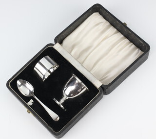 A silver egg cup, spoon and napkin ring Sheffield 1953, 78 grams, cased