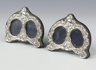 A pair of Victorians style repousse silver double photograph frames, London 1970, 10cm 