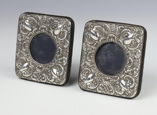 A pair of Victorian style repousse silver photograph frames with scroll decoration London 1989 10cm 