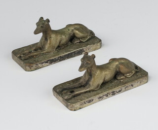 A pair of Edwardian silver plated knife rests in the form of reclining hounds 6cm 