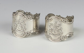 A pair of Victorian silver napkin rings with repousse armorial decoration Sheffield 1895, 76 grams 