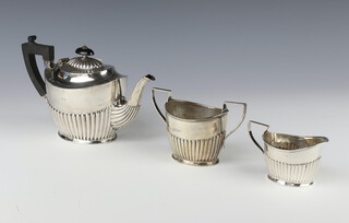 A Victorian silver demi-fluted 3 piece tea set with ebony mounts, Birmingham 1885, gross weight 643 grams 