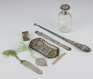 An Edwardian repousse silver pin tray decorated with Reynolds angels Birmingham 1902, 3 bookmarks, a button hook, mounted scent and box, weighable silver 49 grams, together with a gilt tooth pick   