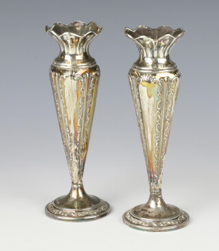 A pair of Edwardian silver posy vases with repousse scroll decoration Sheffield 1903, 17cm