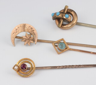 An Edwardian yellow metal 15ct ruby and pearl tie pin and 3 others