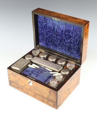 A Victorian walnut toilet box containing 7 boxes with silver plated mounts, 4 bottles and minor mother of pearl handled implements and base drawer 