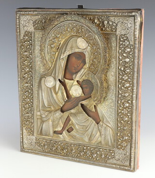 A 19th Century Russian icon depicting Mary and The Boy Child with repousse silver floral ocklad 32cm x 26cm 