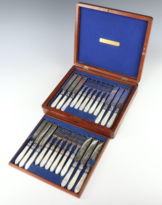 A mahogany canteen containing a set of silver plated and mother of pearl dessert eaters for 18 with engraved blades , contained in a mahogany canteen