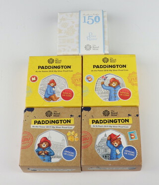 Two Royal Mint Paddington silver proof coins 2018 "At The Station", 2 silver Paddington 50 pence coins 2019 "At The Tower" and a ditto Beatrix Potter 2016 proof 50p coin, all boxed  