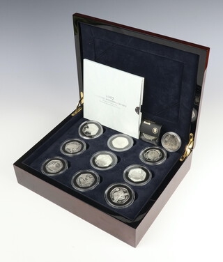 Eighteen commemorative silver crowns 2007, 504 grams, cased, together with 4 cupro nickel commemorative coins 