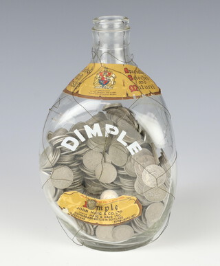 A Dimple bottle containing a large quantity of sixpences, a quantity of commemorative crowns