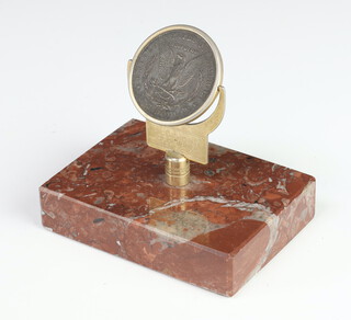 An 1878 one dollar coin mounted on a brass stand and marble base to swivel, engraved "Decisions, decisions, decisions" 