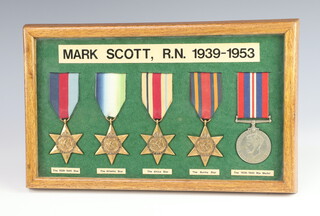 A World War Two group of medals framed, comprising British War medal, 1939-45, Atlantic, Africa and Burma stars to Mark Scott RN.1939-1953  