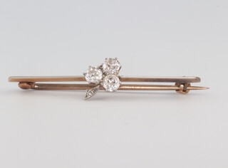 A yellow and white metal bar brooch set with 3 diamonds in the shape of a flower, each stone approx. 0.15ct, 2 grams, 35mm 