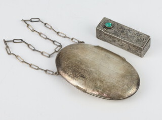 A German white metal oval engraved compact and coin holder suspended from a white metal chain together with a white metal Art Deco engraved lipstick holder with green glass cabochon mount 