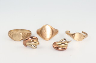 A 9ct yellow gold signet ring size R, a ditto size T 1/2, a cut ditto and a pair of ear studs 10.9 grams 