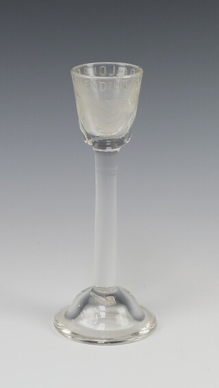 An 18th Century style cordial glass etched roses, engraved 'Health to all our fast friends' on a spreading foot 17cm h  