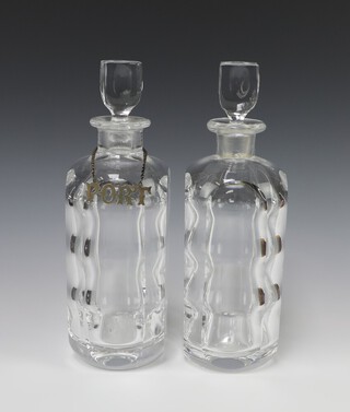 A pair of Orrefors panel cut decanters and stoppers, base marked Orrefors P2508-11, 28cm, 1 with a silver plated port label 